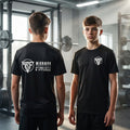 Person wearing a black t-shirt with a logo in a gym setting