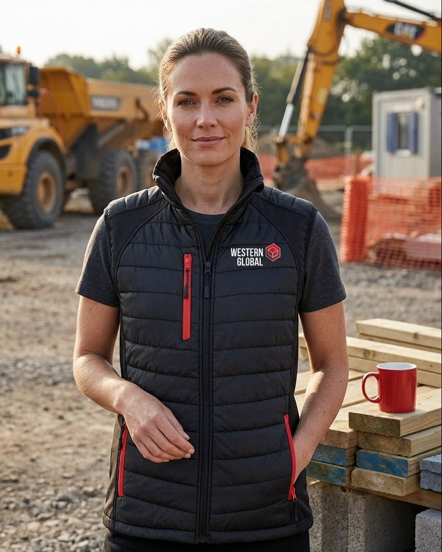 Woman wearing a black vest with a logo on a construction site